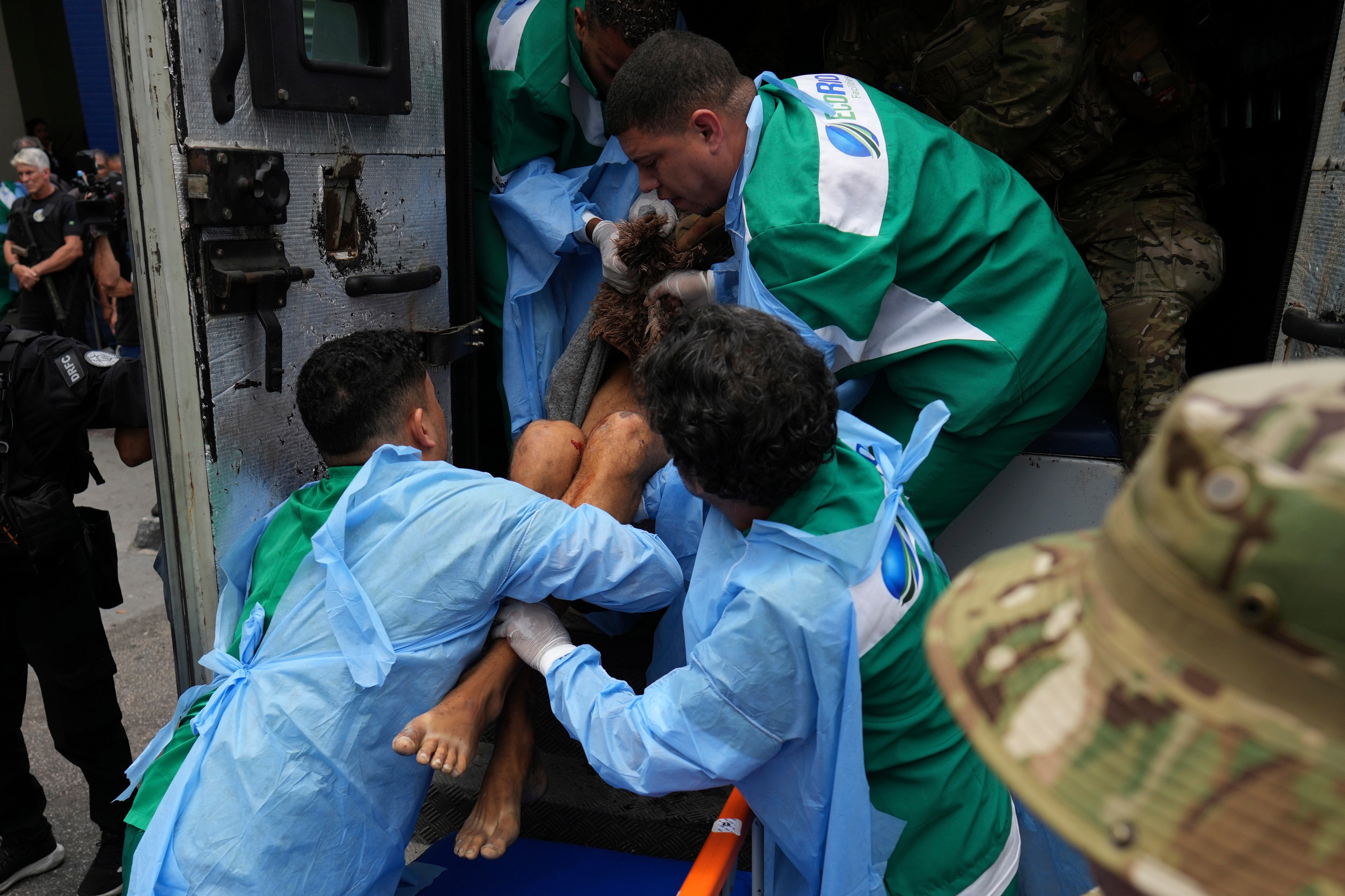 Getulio Vargas Hospital workers remove an injured person from a police truck after he was injured in a police operation against alleged drug traffickers in the Complexo do Alemao favela where the criminal organization "Comando Vermelho" operates in Rio de Janeiro, on Tuesday.